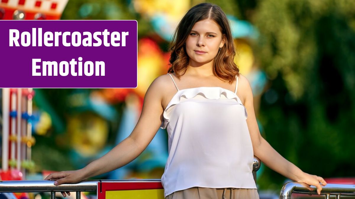 White woman stands near carousel in park at daytime.