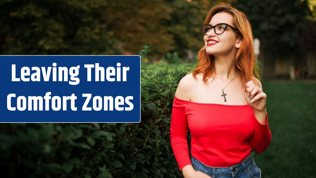 Attractive redhaired woman in eyeglasses wear on red blouse and jeans skirt posing at green park.