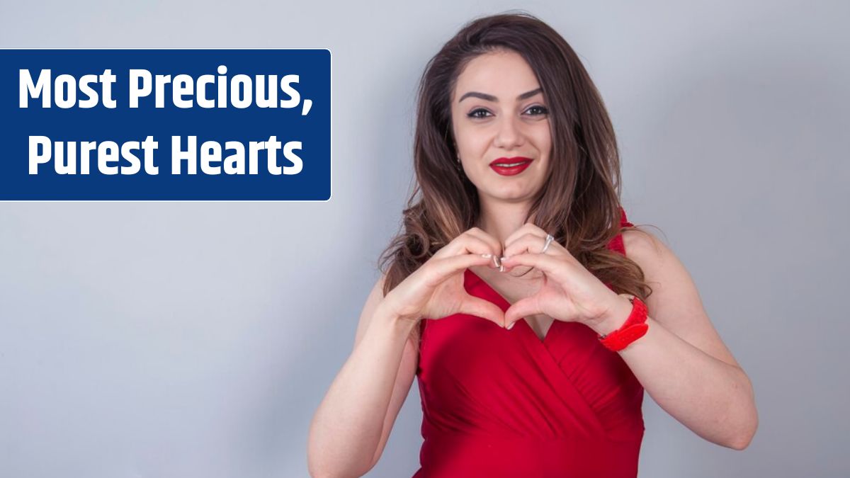 Photo of happy woman smiling and showing heart shape with hands.