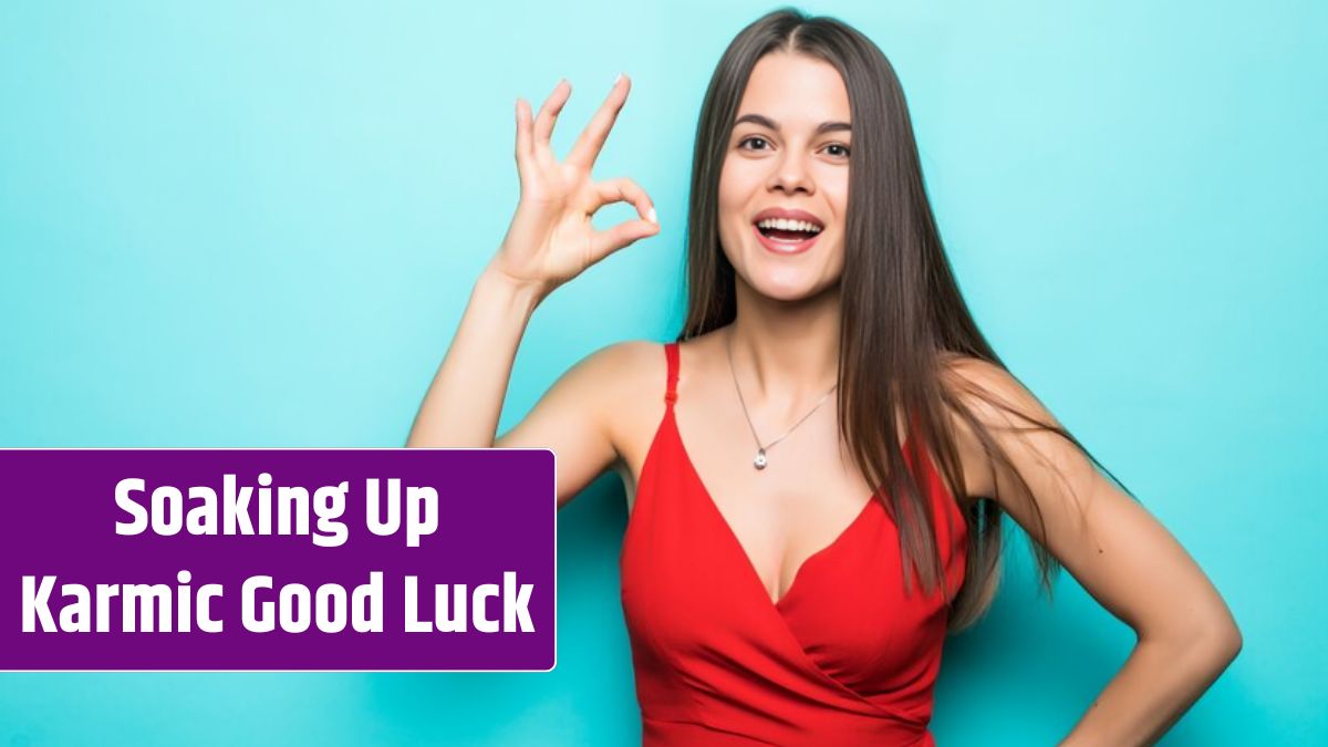 Portrait of happy smiling woman wearing red dress showing OK gesture, thumbs signal copy space isolated on blue wall.