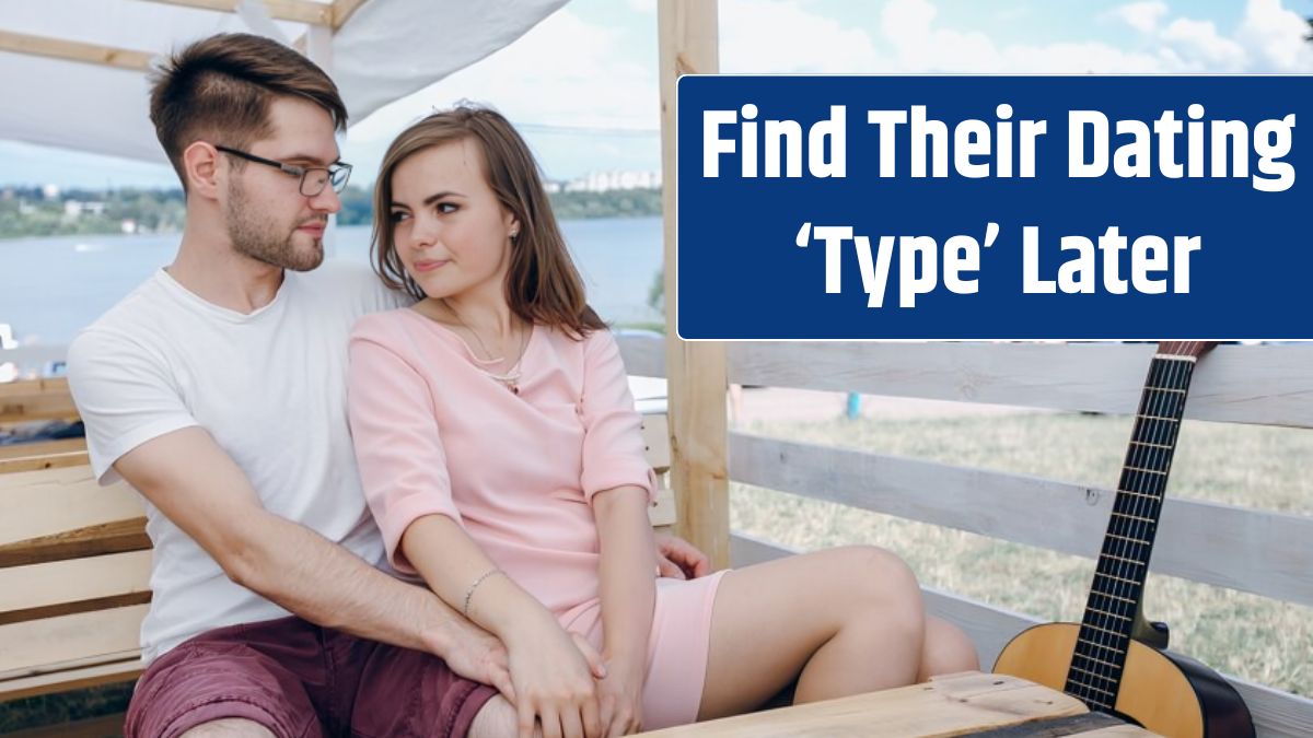 Loving couple sitting on a wooden bench with a guitar next to it.