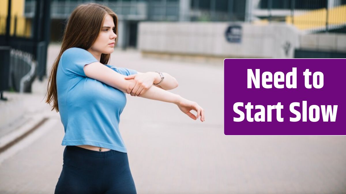 Teenager stretching arm on street.