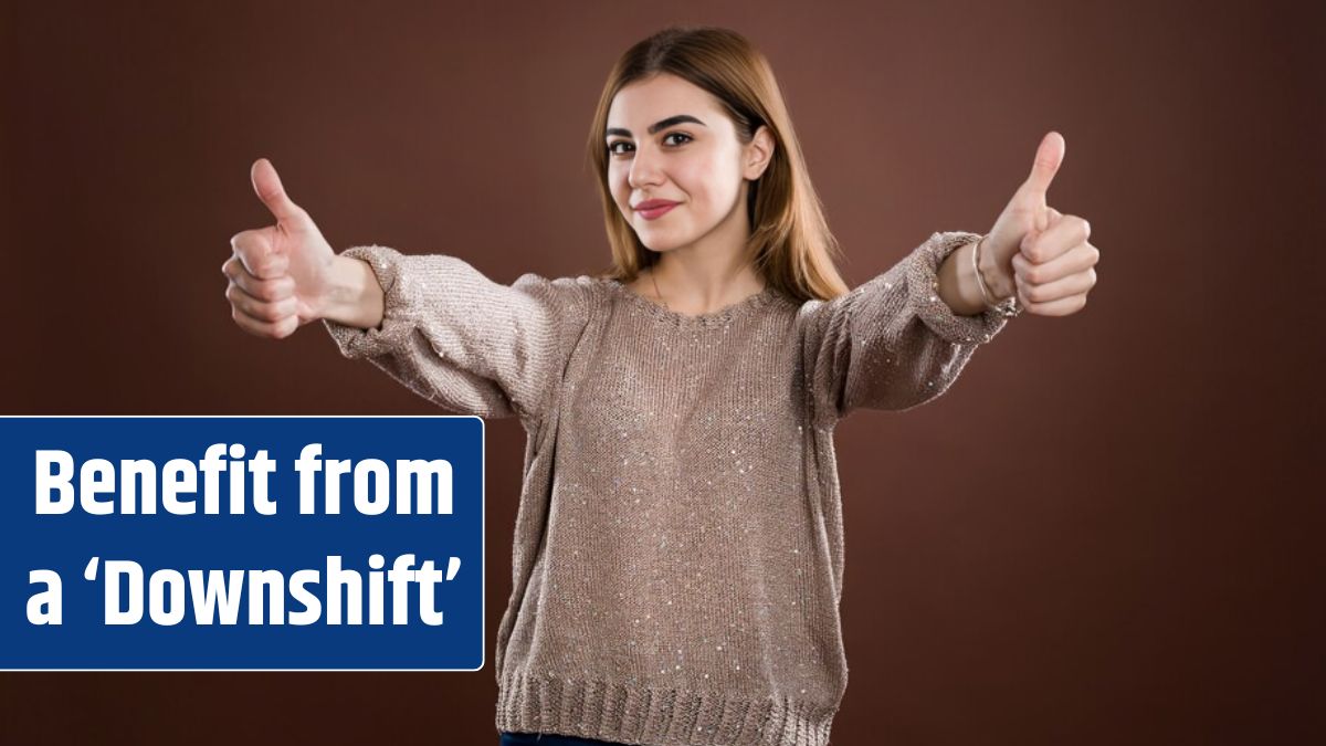 Portrait of young woman showing thumbs up.