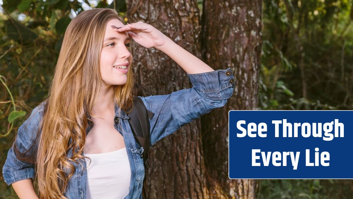 Close-up of a happy young woman shielding her eyes.