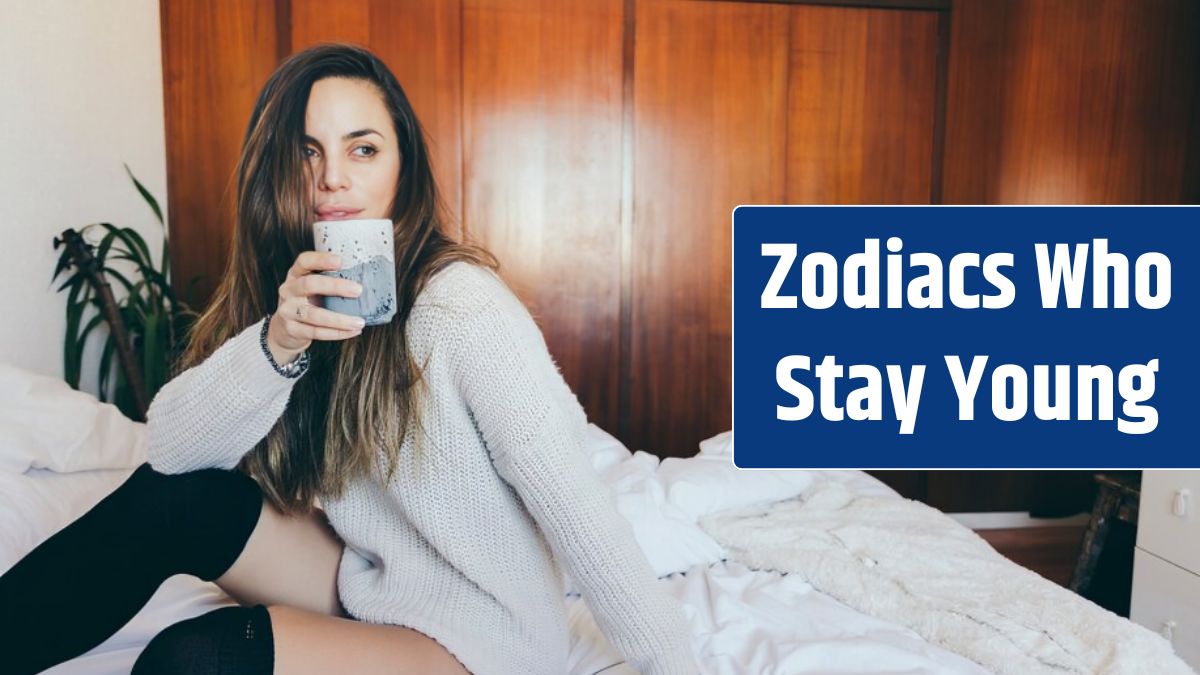 Sensual woman drinking hot beverage in bed.